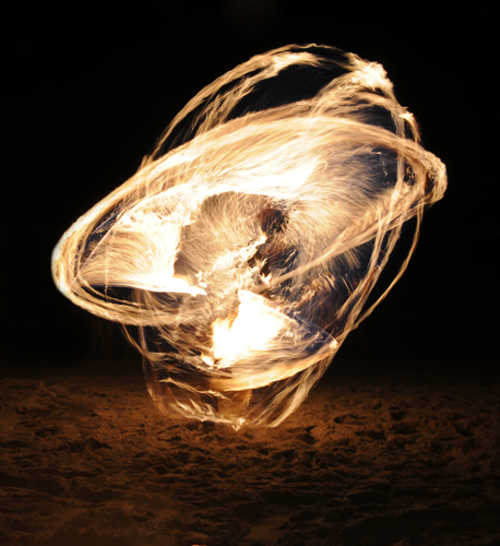 Golden Gardens fire spinner dancer performance at Bonfire and Christmas Tree Immolation party